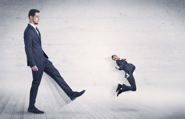 Giant man kicking out small man from space with grungy background

