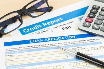 Loan application form fair credit score with calculator, glasses, and pen