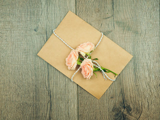 Envelop with white card and rose background. Top view., Envelope with flowers summer, spring.