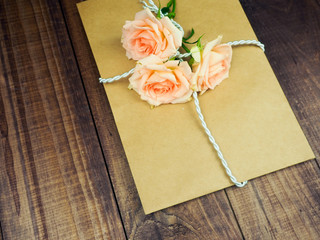 Envelop with white card and rose background. Top view., Envelope with flowers summer, spring.