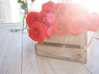large bouquet of roses in a wooden box on a wooden background, for postcards, greetings, space for text