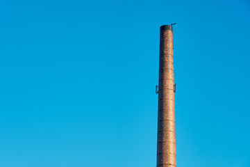Rare pipe against a blue sky. Copy space.