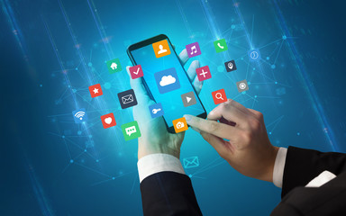 Female hand using smartphone with colorful application icons around