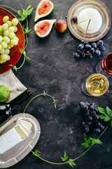 Red Wine Grapes Figs and Cheese on the Black Background