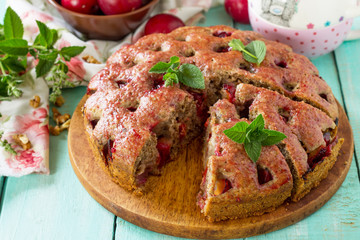 Delicious dessert plum pie, sweet delicious holiday cake with plums and nuts.