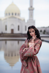 girl on the background of the mosque