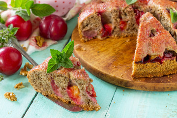 Delicious dessert plum pie, sweet delicious holiday cake with plums and nuts.