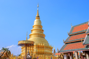 Naklejka premium Golden pagoda at Wat Phra That Haripunchai Woramahawihan in Lamphun, north of Thailand