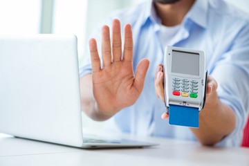 Man processing credit card transaction with POS terminal