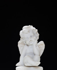 Fototapeta na wymiar Figurine Of Baby Angel On Black Background 2