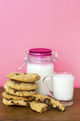 homemade white and black chocolate cookies on wood table with milk