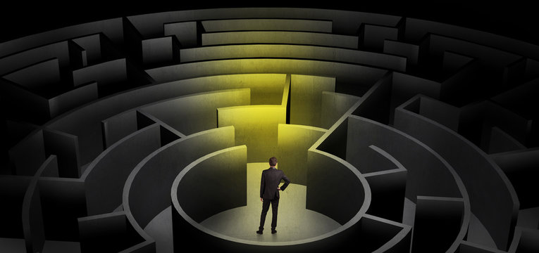 Businessman can not decide which entrance to chose in a middle of a dark maze
