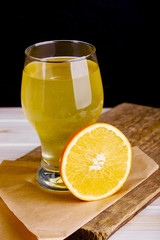 A glass of freshly squeezed orange juice with an orange slice