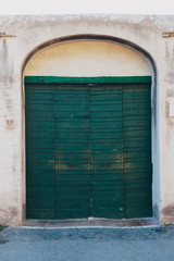 Green wooden old door in Rome, Italy