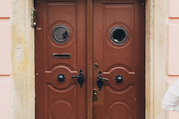 Wooden old door with circle windows in Prague