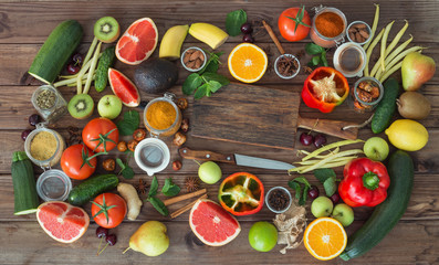 Healthy food, clean food selection:  fruits, vegetables, seeds, spices on brown boards 