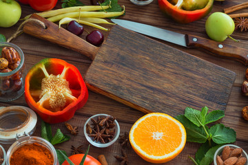Healthy food, clean food selection:  fruits, vegetables, seeds, spices on brown boards with free space in the middle