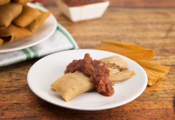 Homemade Tamale Unwrapped and On a Plate with Salsa