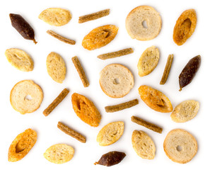 Different crackers for beer and sausages on a white. The view from the top.