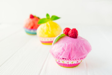 Concept of artificial, plastic food. GMO, E numbers and genetically modified sweets. Use of chemicals in the food industry. Future food Technology. Unhealthy snacks on white background. Copy space.