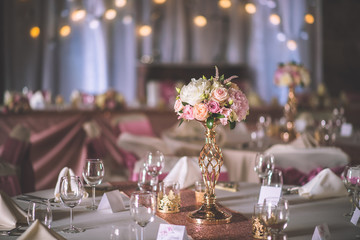 wedding table with exclusive floral arrangement prepared for reception, wedding or event centerpiece in rose gold colour - obrazy, fototapety, plakaty