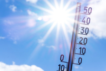 bright sun with thermometer. Summer background