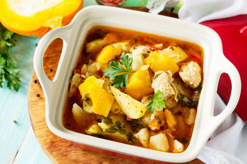Turkey stew with pumpkin, vegetables and spices in a bowl on a wooden table in a rustic style. The concept  thanksgiving food.