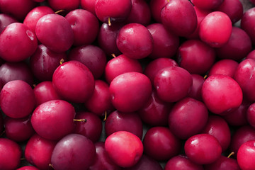 Ripe juicy plums as background