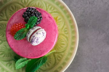 Tasty berry mousse cake on plate