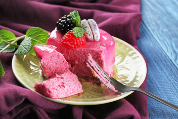 Tasty berry mousse cake on plate