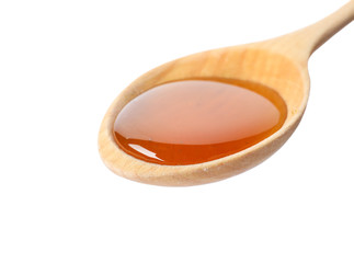 Spoon with delicious honey on white background