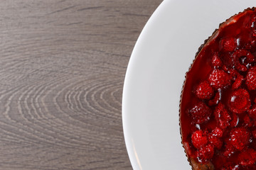 Raspberry jelly cake. The view from the top, flat at the top. Copy space and text. On a wooden table