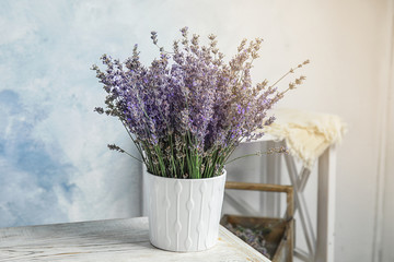Pot with blooming lavender flowers on table