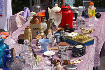 Weekend flea market jumble sale in the city center on a sunny day. Market booth with objects for...
