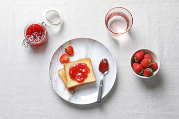 Flat lay composition with toast bread, strawberries and jam on table