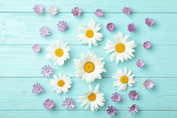 Flat lay composition with wild flowers on wooden background