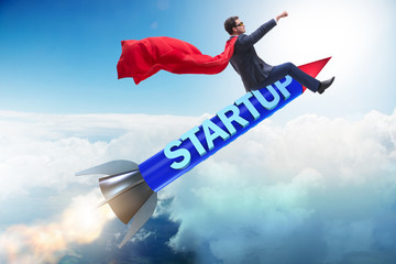 Superhero businessman in start-up concept flying rocket