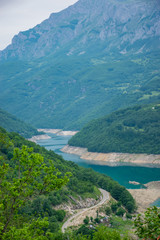 An unusual mountain lake with turquoise water is located in a canyon among the high mountains.