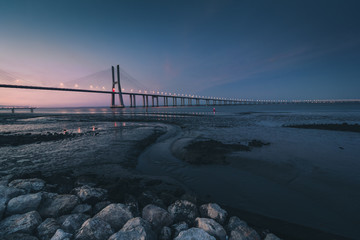 View of amazing Vasco da Gama Bridge at sunset. The Vasco da Gama Bridge crosses the Tagus River, and is one of the longest bridges in the world. Lisbon. Portugal.