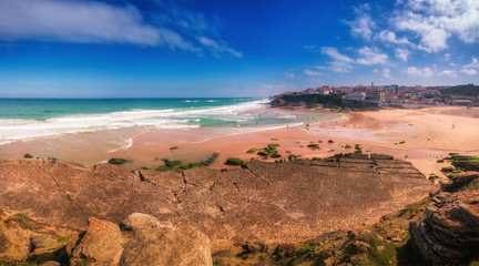 Panorama of the beach of Praia das Macas. View of the The beach is excellent with golden sand and clear sea water, big waves. Coast of the Atlantic Ocean. Portugal. 