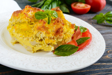 Tasty useful casserole from cauliflower on a plate on a dark wooden background. Vegetarian menu. Proper nutrition.