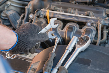 Fototapeta na wymiar car repair tool in mechanic's hand