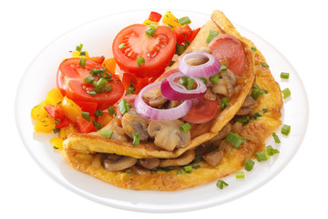 Omelet with mushrooms, sausage and tomatoes on a plate is decorated with onions. Isolated on white background.