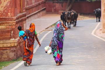 Local women walking along the wall of Taj Mahal complex in Agra, Uttar Pradesh, India