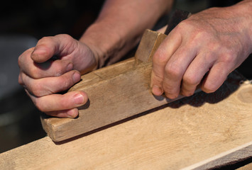 A man working with a wooden plane