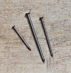 Three nails on a wooden board