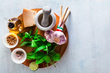 fresh ingredients for cooking Italian classic green pesto basil sauce. with pine nuts, garlic and parmesan cheese. copy space