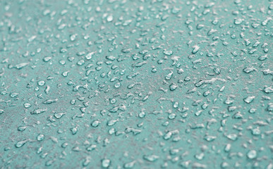 Small droplets on a turquoise surface