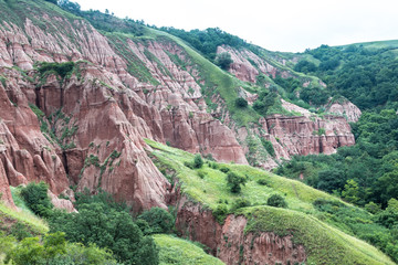 Red Ravine (Rapa Rosie) geological reserve in The Carpathian Mountains similar to Cappadocia. Rock...