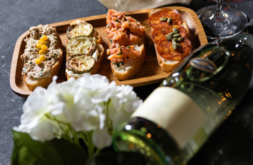 Wine bottle, glass and snacks on the table